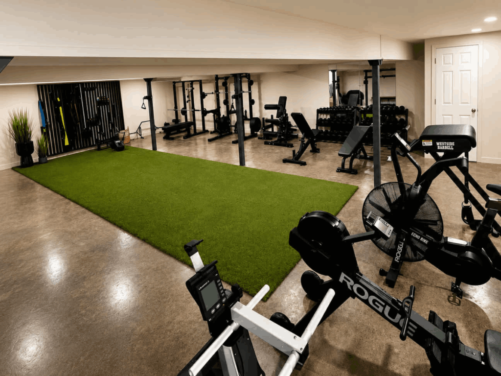 Interior of Vitruv’s private personal training studio in Waterbury, Vermont, featuring turf, strength equipment, and cardio machines.
